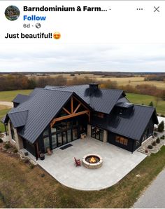 an aerial view of a large house with a fire pit in the middle of it