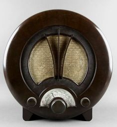 an old fashioned radio sitting on top of a wooden stand