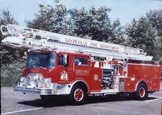 a red fire truck parked in a parking lot