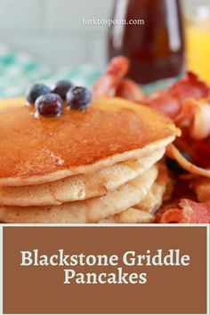 pancakes topped with blueberries and bacon on a plate