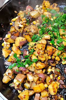 some food is cooking in a skillet on the stove and ready to be eaten