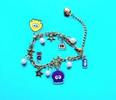 This bracelet features small acrylic charms : -Squid -Octopus -Drink Ticket -Drink Pouch -Ink Tank on your choice of gold or silver bracelet. Splatoon Inkling, Drink Ticket, Acrylic Charms, Splatoon, Charm Bracelets, Octopus, Silver Bracelet, Jewelry Bracelets, Charm Bracelet