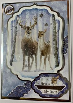 two deer standing next to each other in front of snow covered trees with the words have a my deer written on it