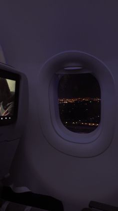 the view from inside an airplane window at night