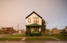 a small white house sitting on the side of a road