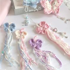 several crocheted hair ties are laying next to a box with beads and charms