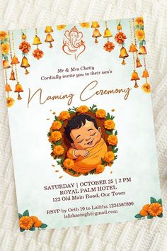 an orange and white baby announcement card with a buddha image on it's front