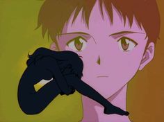 an anime character with brown hair and green eyes holding a black object in his hand