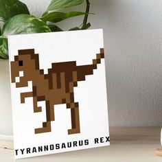 the tyransauruss rex pixel art boarder on a table next to a potted plant