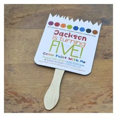 a wooden spatula with the words jackson is turning five come paint with me on it