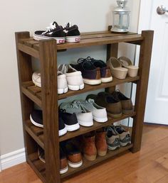 a wooden shelf filled with lots of shoes