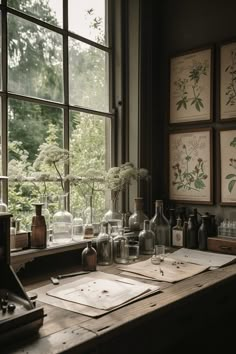 an old desk with vases and other items on it in front of a window