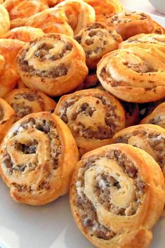 sausage pinwheels on a white plate with the words sausage pinwheels above it