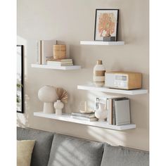 three white shelves on the wall above a couch