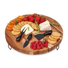 a wooden platter with cheese, crackers and raspberries on it is shown