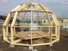 a large wooden structure sitting on top of dirt