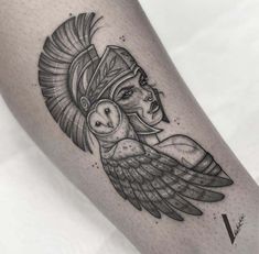 a woman with an owl tattoo on her leg