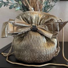 "Vintage Evening Purse in gold fabric textured materials with bow and some rhinestone  detail.  Drawstring in bucket  style with cord strap . Satin lining. Never worn Approximately 8\" x 8\"" Elegant Formal Shoulder Bag With Bow, Luxury Shoulder Bag With Bow For Party, Luxury Party Shoulder Bag With Bow, Chic Party Bag With Ribbon Detail, Chic Party Bag With Ribbon, Gold Bucket Bag For Evening, Gold Bucket Bag For Formal Occasions, Evening Bags With Satin Bow, Gold Bucket Shoulder Bag For Formal Occasions