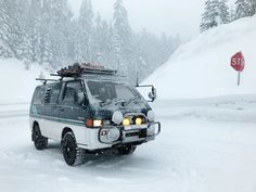 an off road vehicle driving through the snow