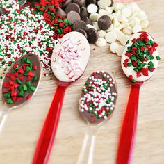 spoons filled with candy and sprinkles sitting on top of a table