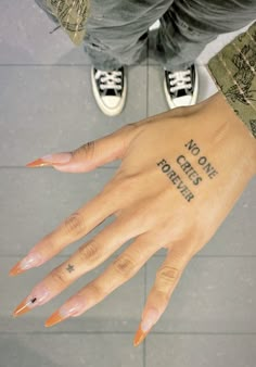 a person's hand with tattoos on it and the words, no one cares for this