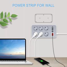 an electric outlet plugged in to a laptop computer on a desk with power strip for wall