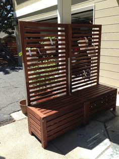 a wooden bench sitting on top of a sidewalk