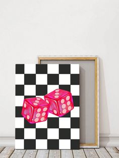 two pink dices sitting on top of a black and white checkered board