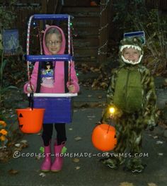 two children dressed up in halloween costumes holding pumpkins and buckets with lights on them