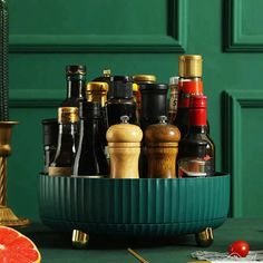 a green bowl filled with lots of different types of condiments next to a candle