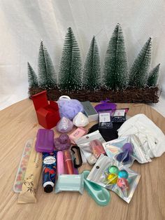 various items are sitting on the floor in front of a basket with christmas trees behind it