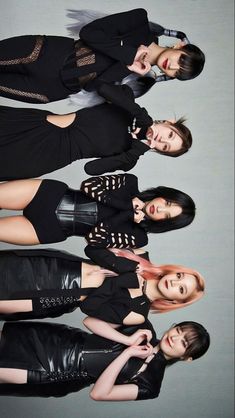 four young women in black outfits posing for the camera