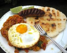 a white plate topped with rice, meat and an egg