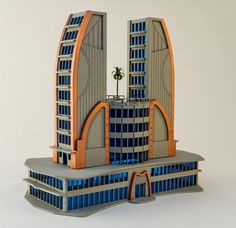 an architectural model of two skyscrapers with blue and orange colors on the sides, against a white background