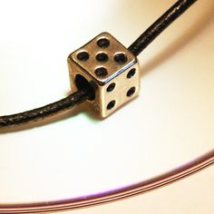 Get 15% off your order when you buy 2 items :) I put a Spell on your Dice. It will bring you good luck wherever you go. Dice size: 9.5mm Shows numbers 2,3,4,5 Silver plated with black dots. Rubber cord necklace with extension chain. You have a choice of 3 finishes for the necklace. Rubber cord with an extension chain is a popular choice for the guys. 2mm black leather cord with a sterling silver lobster clasp is a fine choice. Also you may order a thin sterling silver chain, 1.5mm thin, 18 inches long. Please select the kind of necklace you want at checkout.  NOTES  ★ I love to make my customers HAPPY.  Please read my Feedback: http://www.etsy.com/people/GeekeryDOO/feedback ★ To see more of my fabulous awesome geekery, click here: http://www.geekerydoo.etsy.com Thanks for stopping by!! gee Luck Spell, Dice Necklace, March Gifts, Good Luck Spells, Play Game, Necklace Men, Unique Gifts For Women, Black Necklace, Black Dots