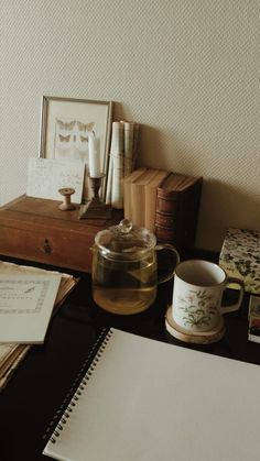 a desk with some books and cups on it