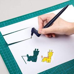 someone is cutting out the shape of a giraffe with a sharpie pen