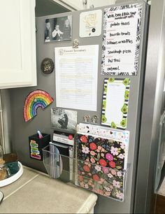 a refrigerator covered in magnets and papers next to a counter top with other items on it