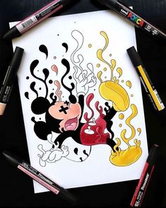 an image of mickey mouse drawing on paper with crayons and markers around it