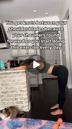 a woman is doing yoga in her kitchen