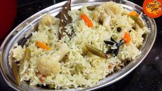 a bowl filled with rice and vegetables on top of a table