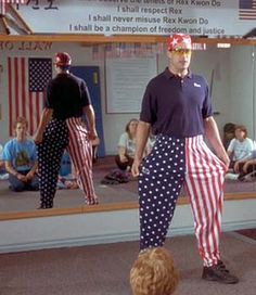 a man standing in front of a mirror with an american flag on it's leg