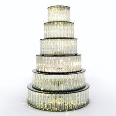 three tiered glass cake stand with lights on top