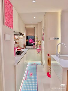 a long narrow kitchen with blue and white checkered flooring on the side wall