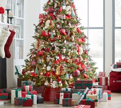 a decorated christmas tree with presents under it