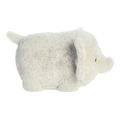 a white stuffed elephant laying down on a white background