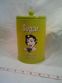 a yellow sugar jar with a woman's face on it and the words sugar will make you happy