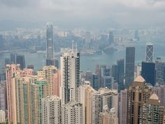 an aerial view of skyscrapers in hong kong, with the ocean in the background