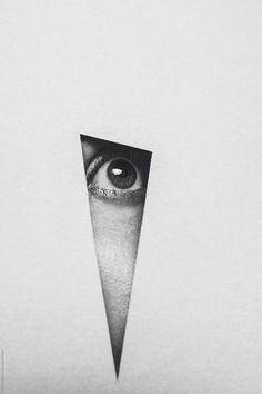 an eye peeks out from behind a piece of paper