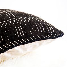 a black and white pillow with arrows on it